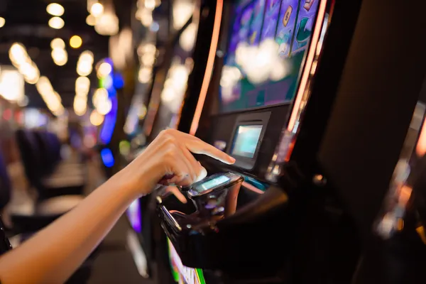 A young woman relaxing with her phone while dynamic casino elements float around her, illustrating the smooth mobile experience offered by the 1XBEF app.