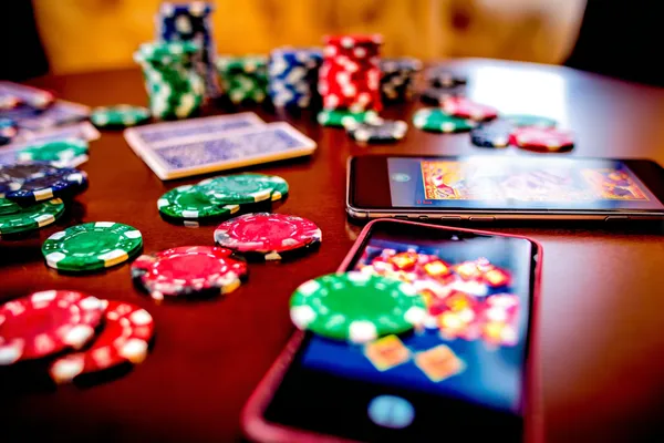 A professional dealer in a tuxedo greeting players at the roulette table, symbolizing the authentic live casino feel at 1XBEF.