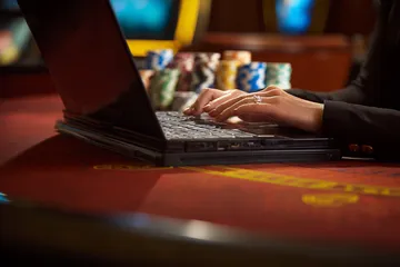 A glowing roulette wheel with cascading chips, symbolizing the engaging live and instant-win games available on 1XBEF.